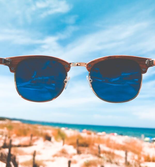 image of sunglasses looking up to a blue sky
